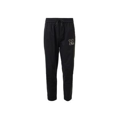 Black jogging pant featuring the letters "M" prominently displayed on the side.