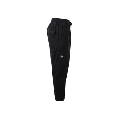 A side view of black jogger pants featuring a zipper pocket, highlighting their trendy and practical cargo style.